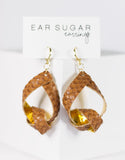 Woven earrings on a 'Ear Sugar' branded card against a white background
