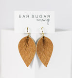 Wooden leaf-shaped earrings on a 'Ear Sugar' branded card against a white background