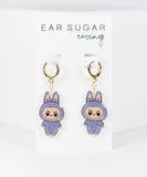 Earring set with cartoon character design on a white background