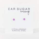 Advertisement for 'Ear Sugar earrings' on a white background with text indicating hypoallergenic and surgical steel material.