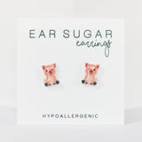 Pig-shaped earrings on a white card with 'Ear Sugar' branding.