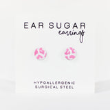 Pair of pink and white patterned earrings on a white background with text indicating 'Ear Sugar earrings' and 'Hypoallergenic Surgical Steel'.